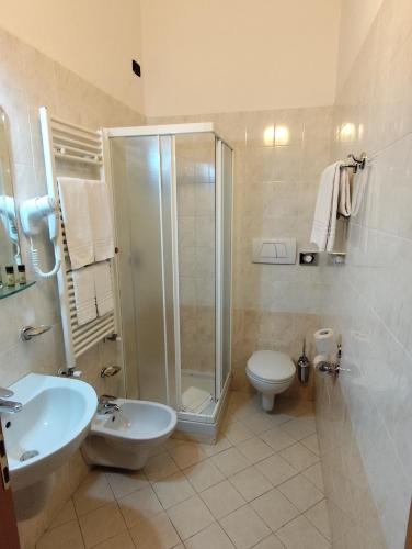 a bathroom with a shower and a toilet and a sink at Hotel Majestic in San Giuliano Milanese