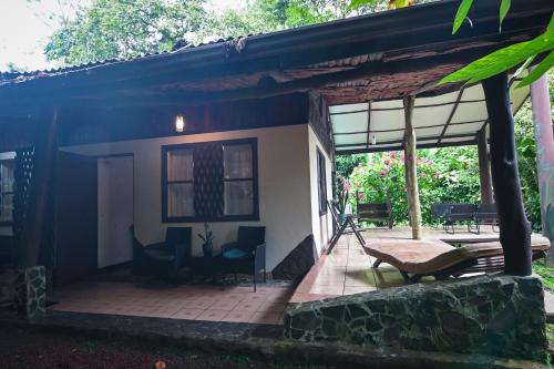a patio of a house with a table and chairs at Chilamate Rainforest Eco Retreat in Puerto Viejo