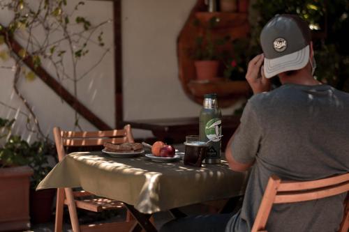 a man sitting at a table with a plate of food at Hotel Turismo in San Martín de los Andes