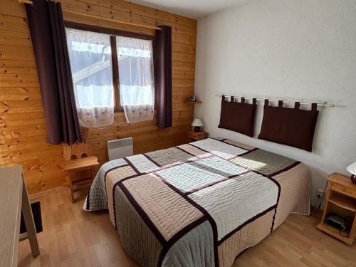 a bedroom with a large bed in a wooden room at Charmant 3 pièces au centre de La Chapelle-d’Abondance avec Multi Pass à 3€/jour/personne ! - FR-1-692-9 in La Chapelle-dʼAbondance