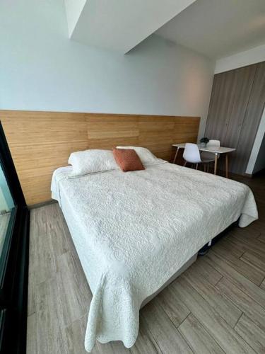 a bedroom with a large bed with a wooden headboard at PRO HOME Balmaceda III in Antofagasta