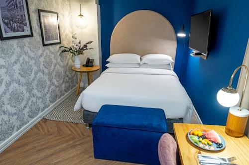 a hotel room with a bed and a table at Faranda Collection Cali, a member of Radisson Individuals in Cali