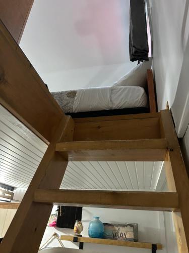 a bedroom with a bunk bed in a room at Aux Pignons Rouges Camping & Chalets in Saint Romain
