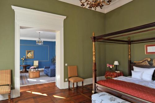 a bedroom with a canopy bed and a living room at Schlosshotel Marihn in Marihn