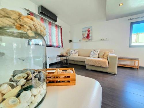 a living room with a vase of shells on a table at Oasis House in Maspalomas