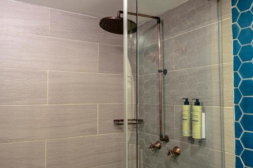 a bathroom with a shower with a glass door at Faranda Collection Cali, a member of Radisson Individuals in Cali