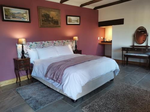 a bedroom with a large bed and a piano at Thatchings Bed and Breakfast in Nottingham Road