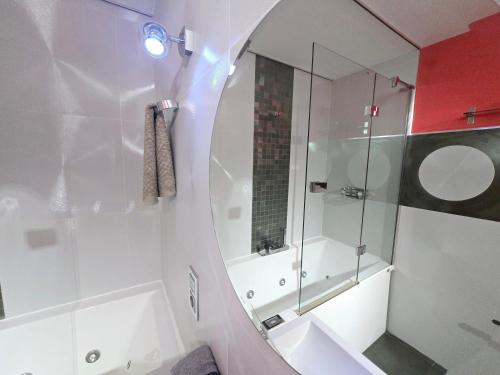 a white bathroom with a mirror and a sink at Oasis House in Maspalomas