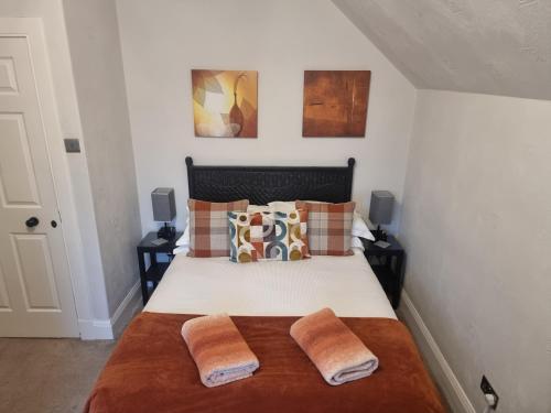 a bedroom with a bed with two pillows at St Leonards Guest House in Largs