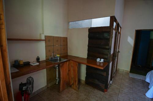 a small kitchen with a sink and a counter at Chilamate Rainforest Eco Retreat in Puerto Viejo