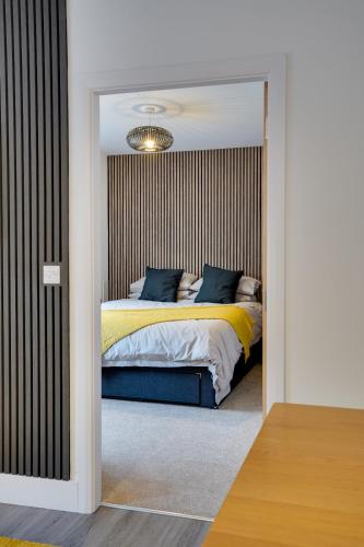 a bedroom with a bed and a mirror at No 4 at The Rocketroom Apartments in Berwick-Upon-Tweed