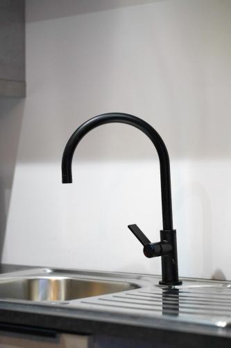 a kitchen sink with a black faucet at No 4 at The Rocketroom Apartments in Berwick-Upon-Tweed