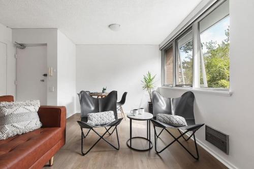 a living room with a couch and chairs and a table at Bright, Stylist apartment in Richmond Terrace in Melbourne
