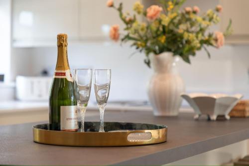 a bottle of champagne and two glasses on a counter at The Caradoc in Shrewsbury
