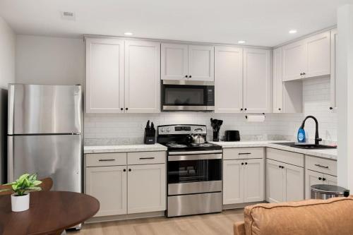 a kitchen with white cabinets and stainless steel appliances at The Silo 4 - 1BD Cozy Retreat in Morton