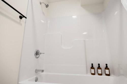 two bottles of wine sitting in a shower at The Silo 4 - 1BD Cozy Retreat in Morton