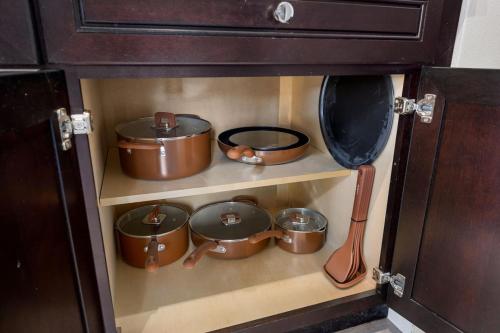 a bunch of pots and pans in a kitchen at Stylish Studio Apartment with Modern Touches in Peoria