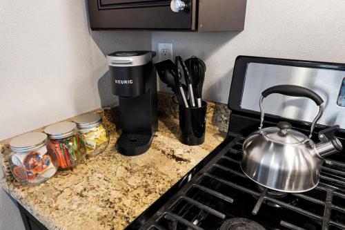 a kitchen counter with a tea pot on a stove at Urban 1BD moments away from DT Peoria in Peoria