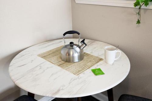 a table with a tea kettle and a cup on it at Urban 1BD moments away from DT Peoria in Peoria