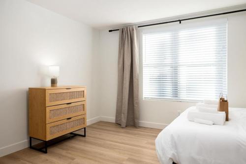 a bedroom with a bed and a dresser and a window at The Silo 7 - 2 FULL BA Double Delight in Morton