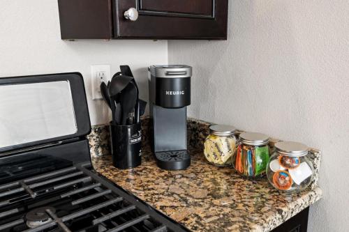 a coffee maker on a counter next to a stove at the susan - a cozy, comfy 1bd suite in Peoria