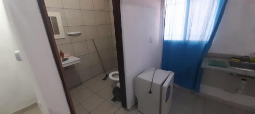 a small bathroom with a toilet and a sink at Avenida Colon in Santiago del Estero