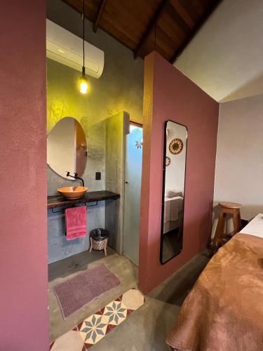 a bathroom with a sink and a mirror at Pousada Ocazum Ilha do Amor in Alter do Chao