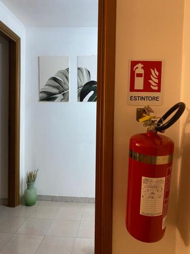 a fire extinguisher is hanging on the door of a room at Lucy house in Ronciglione