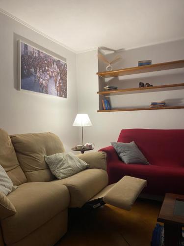 a living room with a couch and a red chair at Lucy house in Ronciglione