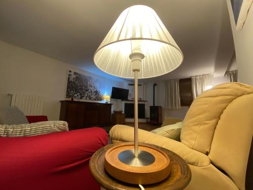 a living room with a lamp and a couch at Lucy house in Ronciglione