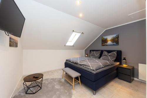 a bedroom with a bed and a tv in a room at Fuldaer Residenz in Fulda