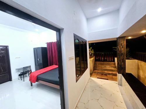 a view of a room with a bed and a hallway at GB25 inn in Trivandrum