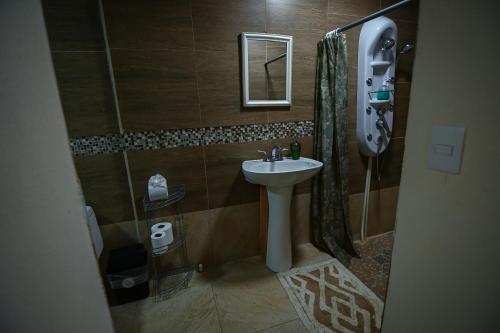 a small bathroom with a sink and a mirror at Chilamate Rainforest Eco Retreat in Puerto Viejo