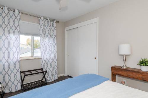 a bedroom with a bed and a window at Stylish Retreat W Modern Comforts! Prime Location in Kettering