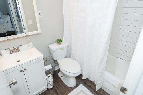 a bathroom with a toilet and a sink and a shower at Stylish Retreat W Modern Comforts! Prime Location in Kettering