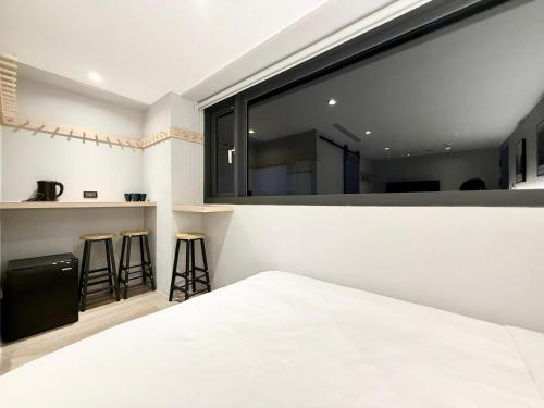 a bedroom with a large window and a bed at N2 Hotel in Taichung