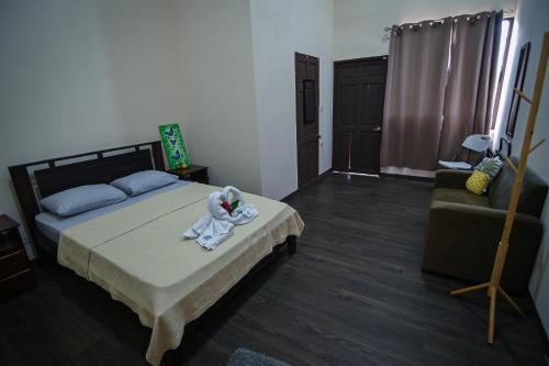 a bedroom with a bed and a couch at Chilamate Rainforest Eco Retreat in Puerto Viejo