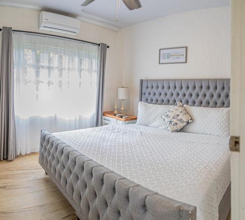 a bedroom with a large bed with a large window at Hotel Villas Gaia Ecolodge in Uvita