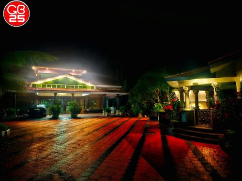 a building at night with lights on a brick driveway at GB25 inn in Trivandrum