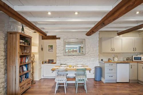 a kitchen with a table and chairs in a room at Beautiful Cottage Parking Central Dunster in Minehead