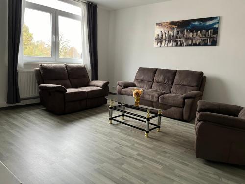 a living room with two couches and a coffee table at Sweet Home in Barsinghausen