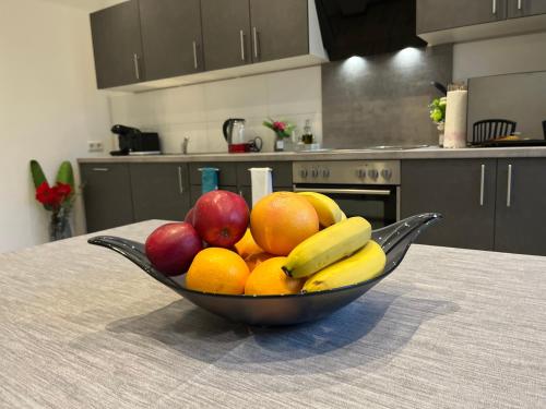 a bowl of fruit on a table in a kitchen at Sweet Home in Barsinghausen