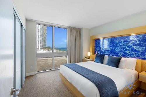 a bedroom with a large bed and a large window at 1BR Apartment with Ocean View in Sunny Isles Beach