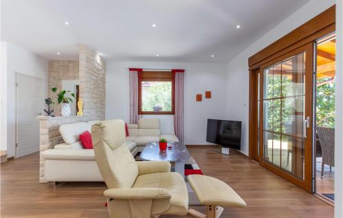 a living room with a white couch and a table at 3 Bedroom Lovely Home In Kostrena in Kostrena