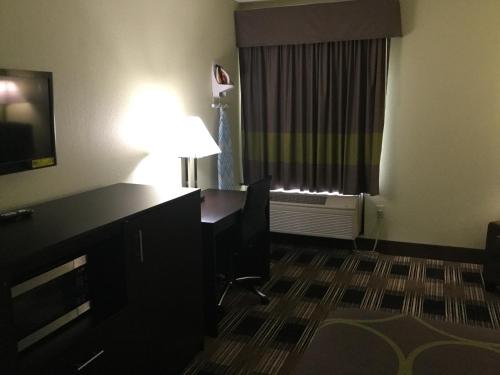 a hotel room with a desk and a window at Super 8 by Wyndham Greer/Spartanburg Area in Greer
