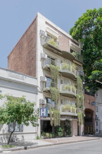 an apartment building with plants on the balconies at Dorrego Premium in Rosario