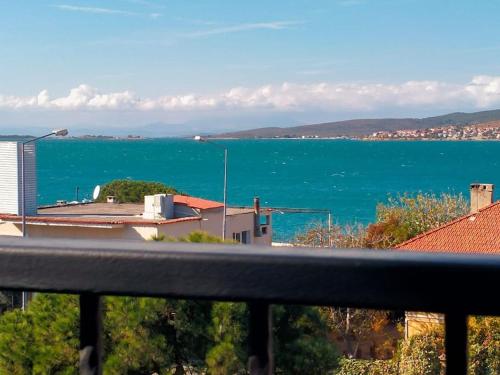 a view of the ocean from a balcony at aj konukevi müstakil ev dört odalı in Ayvalık