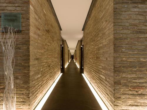 an alleyway between two brick walls with lights at Best Western Hotel Green City in Parma