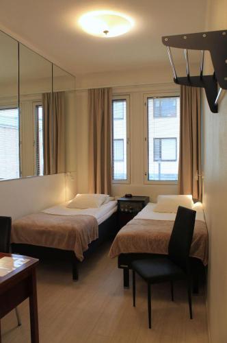 a hotel room with two beds and a mirror at Best Western Hotel Apollo in Oulu