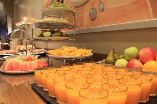 a buffet of fruit and juice in glasses on a counter at Best Western Hotel Apollo in Oulu